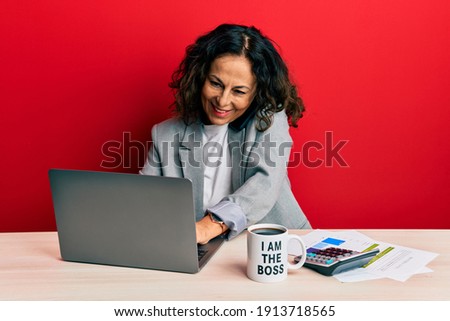 Beautiful middle age woman working at the office talking on the smartphone smiling with a happy and cool smile on face. showing teeth. 