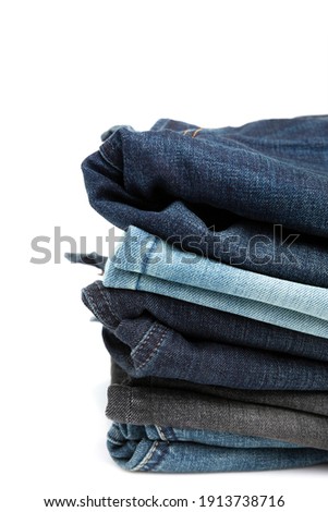 Close up of Jeans stacked on background