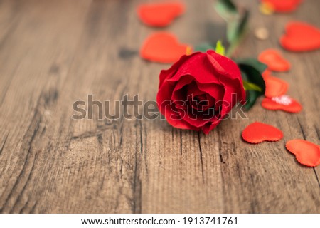 Selective focus rose and red hearts on wooden board, Valentines Day background, wedding day