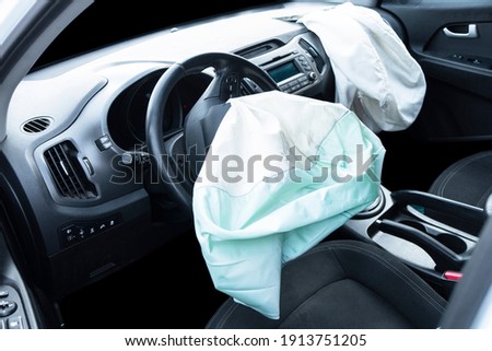 Airbag exploded at a car after the accident. Driver and Passenger AirBag. Car crash. Interior of a car after crash. Inside Automobile Royalty-Free Stock Photo #1913751205