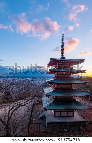 Aerial view of countryside village of Japan with the symbolic red pagoda named Chureito Pagoda and Fuji mountain against sunset light in the evening, shot from an area of Fujiyoshida, Japan Royalty-Free Stock Photo #1913754718