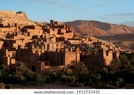 The Moroccan town of Ait Benhaddou with its kasbahs and earth-clay buildings is a UNESCO world heritage site and one of Morocco's  popular destinations. Royalty-Free Stock Photo #1913755435