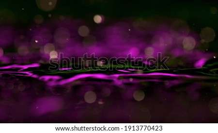 Rippling water surface in neon blue-pink colors with rain drops.