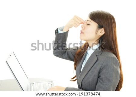 Tired and stressed young Asian business woman