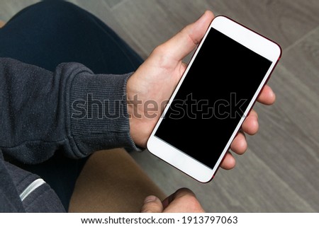 Mock up of smartphone held by the hands of a man. Template for corporate material