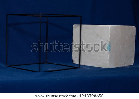 Plaster square and wire loop, mock up for drawing, blue background