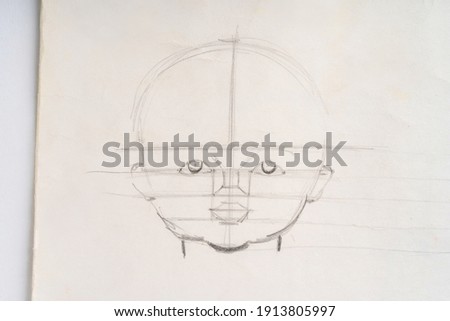Drawing lessons, pencil sketches of a human face on paper