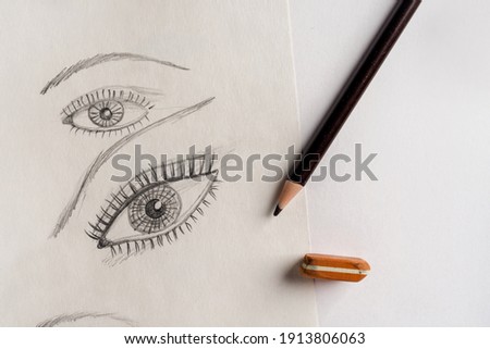 Drawing lessons, pencil sketches of a human face on paper
