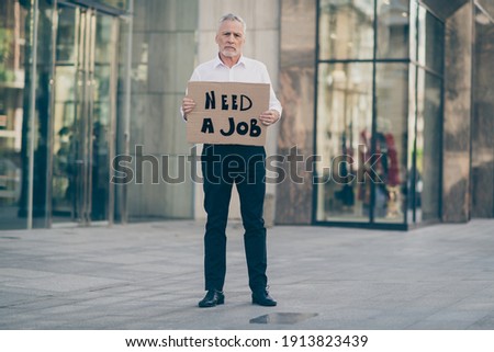 Full length photo of grey haired businessman hold card need job fired misery outdoors building in city center