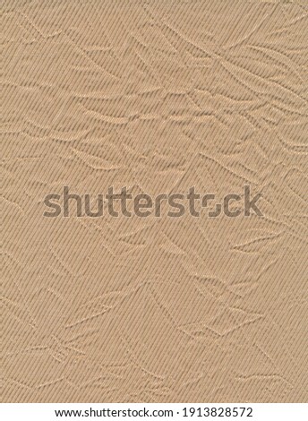 Macro of a beige twill fabric covered in creases