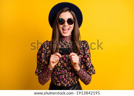 Photo of crazy attractive lady hold debit card open mouth vintage cap isolated on yellow color background