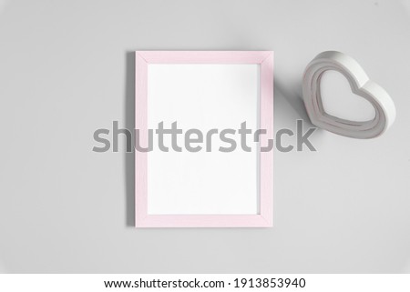 Valentine's Day background. Pink photo frame, hearts, valentines on gray background. Flat lay, top view, copy space