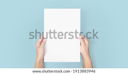 Hands holding paper blank for a letter paper Royalty-Free Stock Photo #1913883946