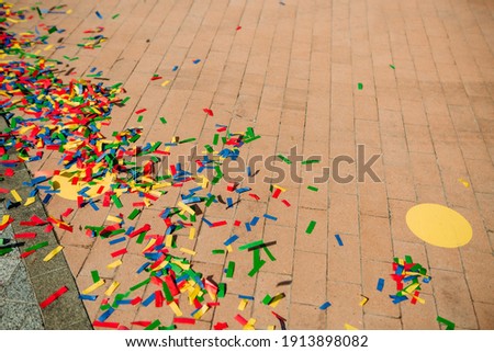 festive decor multicolored paper candy outside on the paving stone
