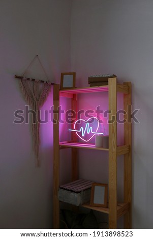 Neon sign pink and blue heart in the decor of the home. Trendy style. Neon sign. Custom neon. Home decor. Valentine day. Modern trendy background.