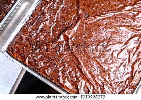 Picture of a freshly baked chocolate brownies surface.