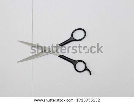 green thread and steel scissors