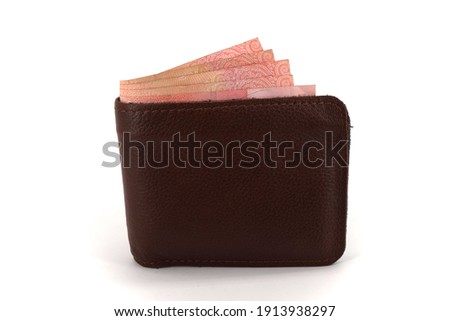 Leather wallet with banknotes inside isolated on white background.                   