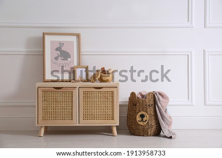Modern child room interior with wooden cabinet and different accessories