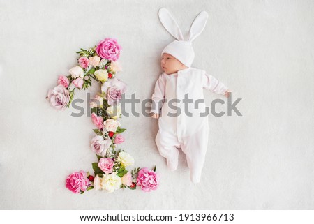 The first month of a baby's life. Newborn baby girl dressed as a bunny. Sweet newborn baby. First photo session of the baby. One month old baby. 