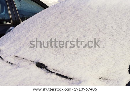 pictured car littered with large snowdrifts
