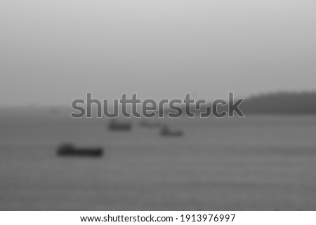 Sea and ships blurred unfocused background. Black and white colors.