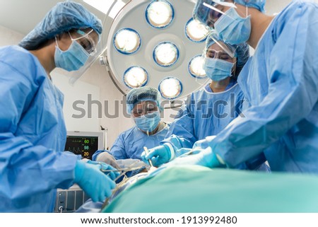 Medical Team Performing Surgical Operation in hospital operating. The medical team doing the critical operations. Royalty-Free Stock Photo #1913992480
