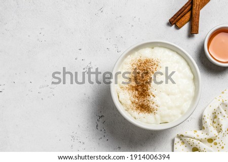 Classic vanilla rice pudding in bowls. Top view, space for text. Royalty-Free Stock Photo #1914006394