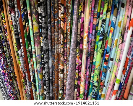 Colorful fabrics textiles on sale in market. Red Yellow blue texture. High quality photo