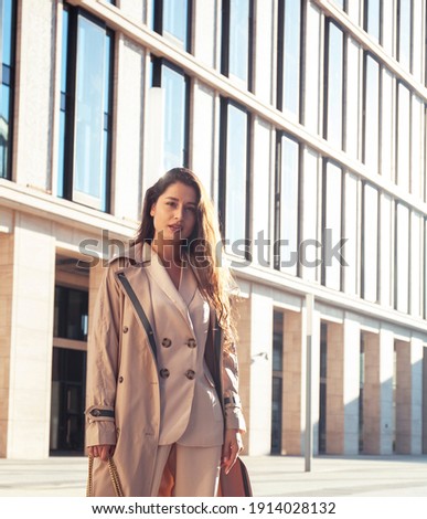 young pretty brunette woman in fashion suit at business building posing cheerful, lifestyle people concept