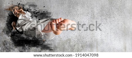 Martial arts master on wall background. Sports banner. Horizontal copy space background Royalty-Free Stock Photo #1914047098
