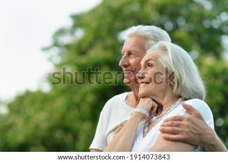 Portrait of beautiful senior couple posing in the park Royalty-Free Stock Photo #1914073843
