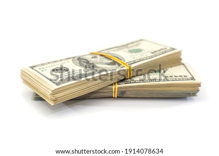 two bundles of one hundred dollar bills tied with an elastic band, isolated on a white background. Royalty-Free Stock Photo #1914078634