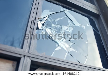 broken glass window reflecting blue sky Royalty-Free Stock Photo #191408312