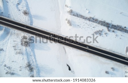 Cars move on bridge road in winter time aerial above drone view