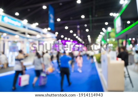 Abstract blur people in exhibition hall event trade show expo background. Large international exhibition, convention center, business marketing and event fair organizer concept. Royalty-Free Stock Photo #1914114943