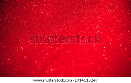 Red background of blurred hearts, side of defocus.