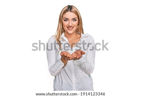 Young caucasian woman wearing casual clothes smiling with hands palms together receiving or giving gesture. hold and protection 