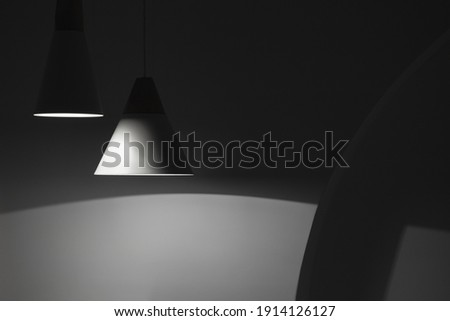 Abstract interior background, hanging spot lights and shadows in dark empty room