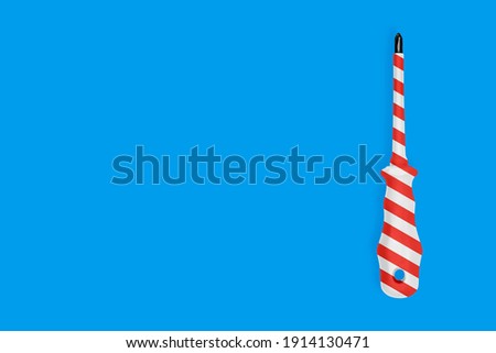 Metal screwdriver with a striped rubberized handle. Background on the theme of tools, service, repair. 