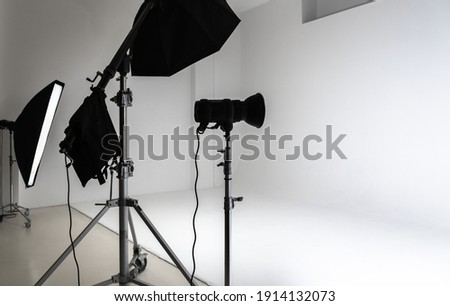 White photo studio interior, cyclorama background and set of professional impulse lights