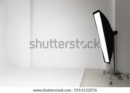 White photo studio interior background, cyclorama structure and soft box impulse light