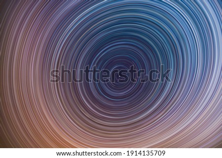 Beautiful starry sky with star trails orientation on the north star. Space background. Abstract long exposure background.