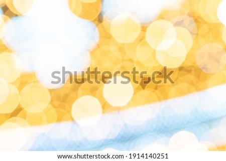 Gold light blur. Abstract Festive glitter Bokeh background. Soft yellow christmas backdrop