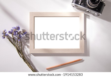 photo frame with lavender and camera on table