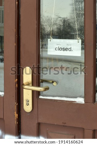 Shop door with sorry we closed sign