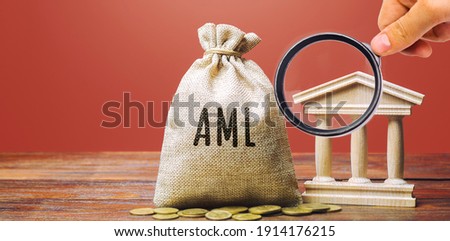 Money bag AML and bank building. Anti Money Laundering concept. Financial monitoring, Identification of suspicious transactions. Business and finance. Fight against criminal money Royalty-Free Stock Photo #1914176215