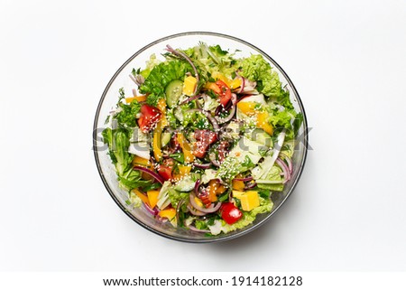 Top view of bowl with green salad on white background. Royalty-Free Stock Photo #1914182128