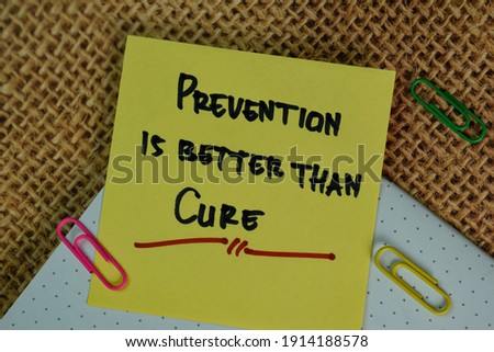 Prevention is Better Than Cure write on sticky notes isolated on Wooden Table.