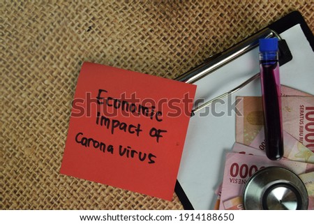 Economic Impact of Coronavirus write on sticky notes isolated on Wooden Table.